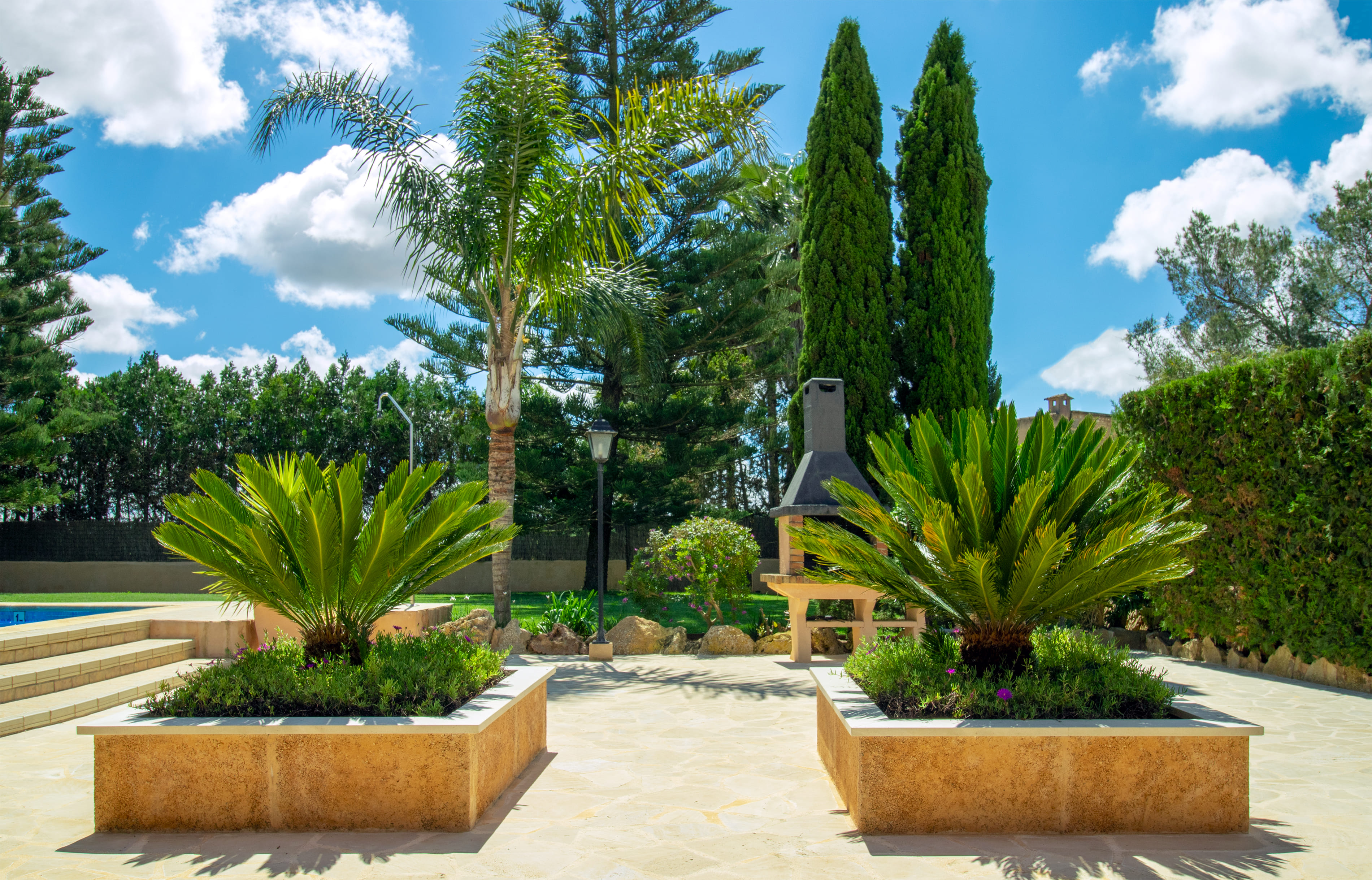 Arrival courtyard with Mediterranean landscaping