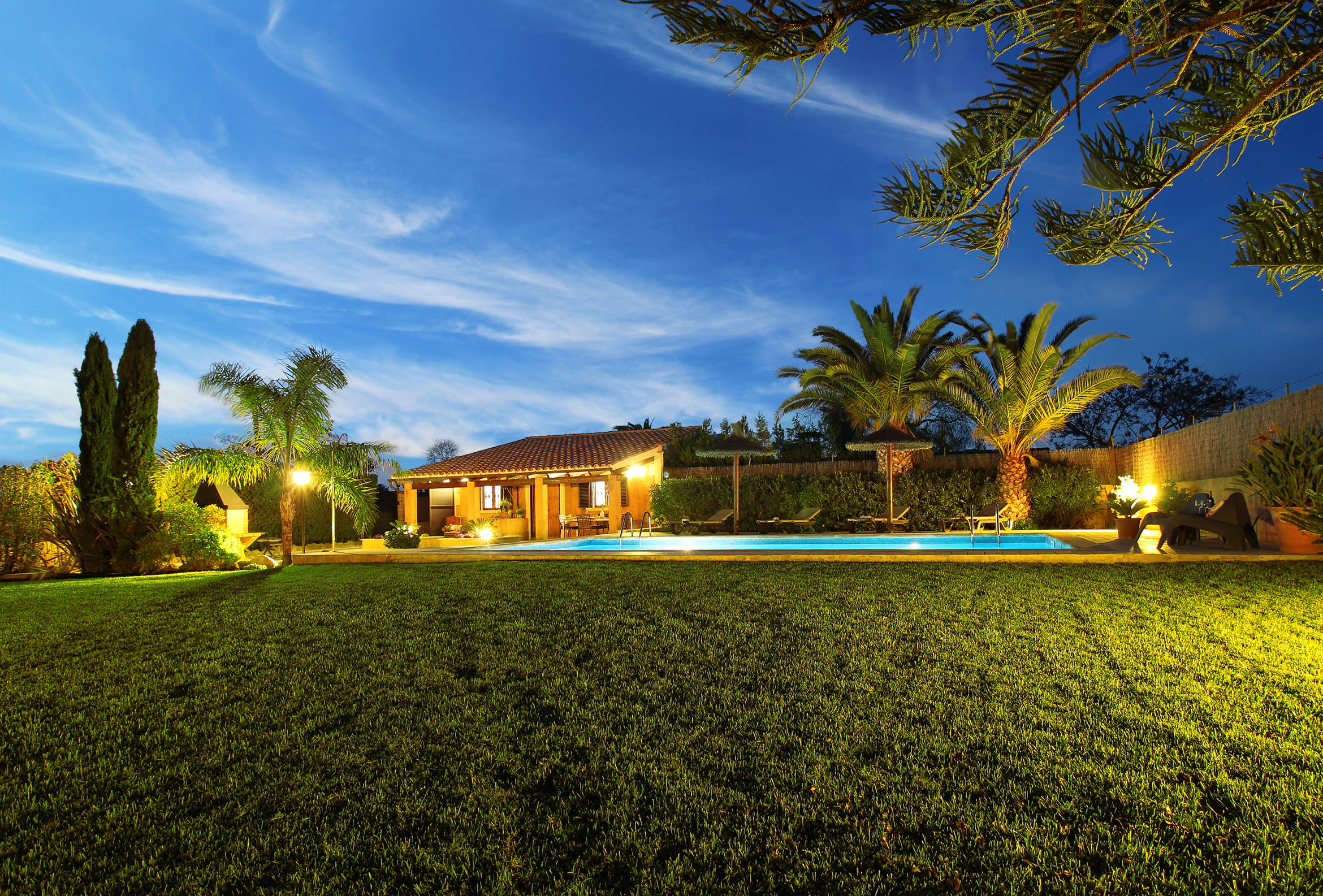Son Llaneras Villa softly lit at dusk